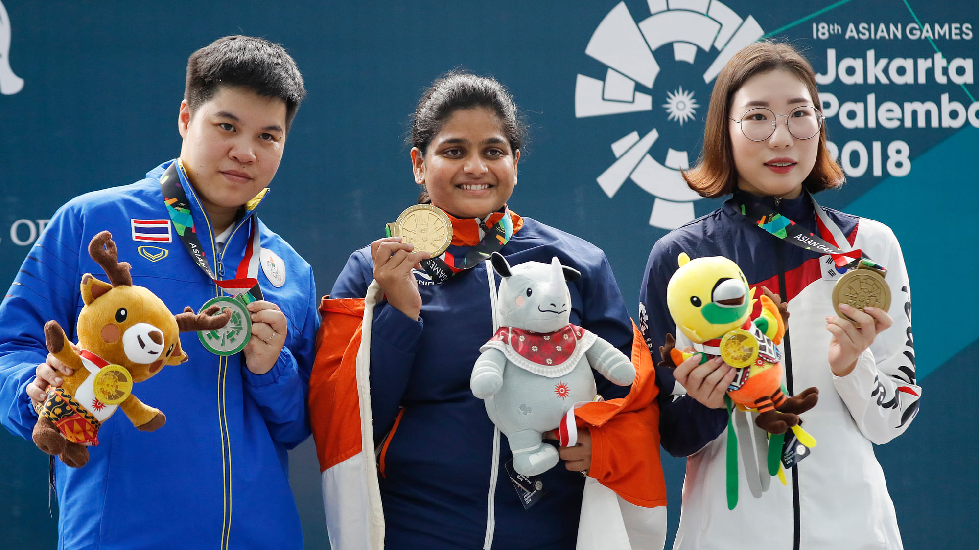 Silver medalist Thailand’s Naphaswan Yangpaiboon, left, gold medalist India’s Rahi Jeevan Sarnobat, center, and bonze medalist South Korea’s Kim Minjung display their medal the final round of the 25m pistol women’s shooting event at the 18th Asian Games in Palembang, Indonesia, Wednesday, Aug. 22, 2018.&nbsp;