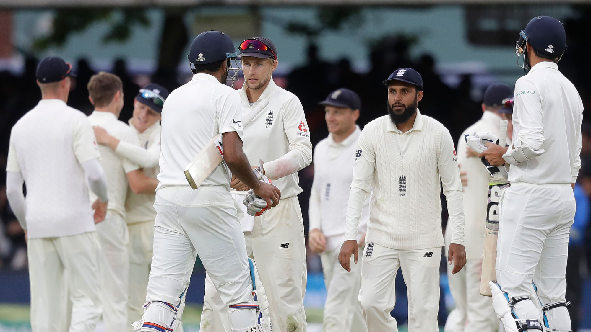 Players shake hands after England bowl India out for 130 during the fourth day of the second test match between England and India at Lord’s cricket ground in London, Sunday, Aug. 12, 2018.
