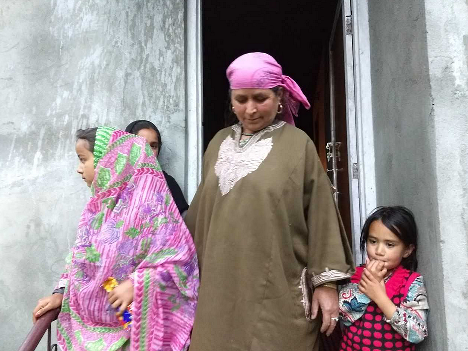 Saleema, mother of Altaf Kachroo outside their home in Hawoora Mishipora.