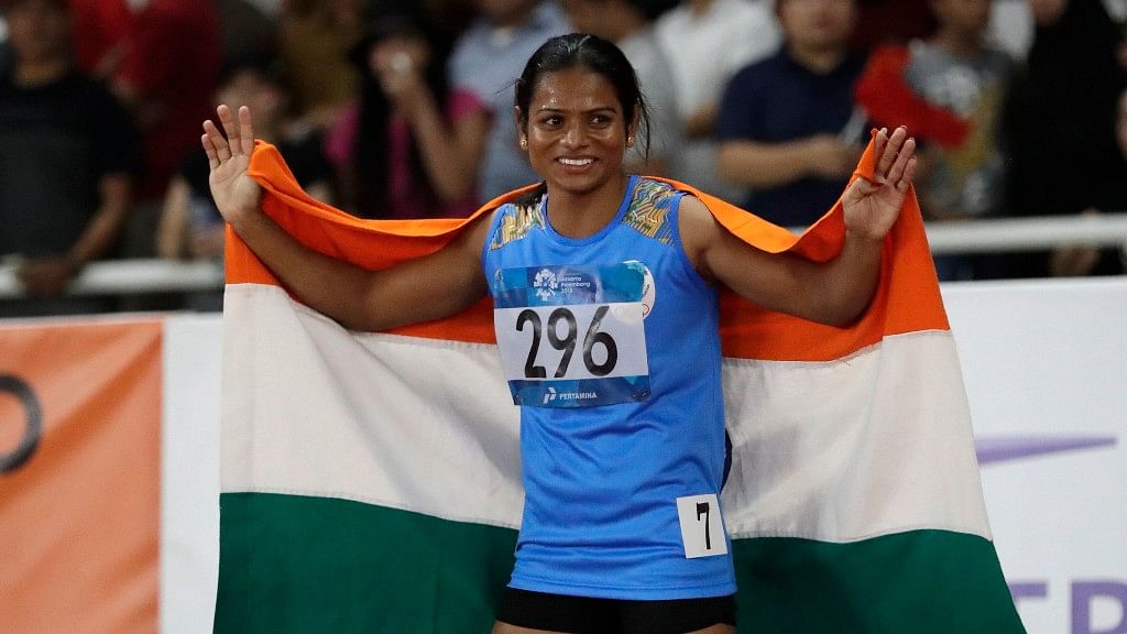 India’s Dutee Chand celebrates after her second place finish in the women’s 100m final during the athletics competition at the 18th Asian Games.