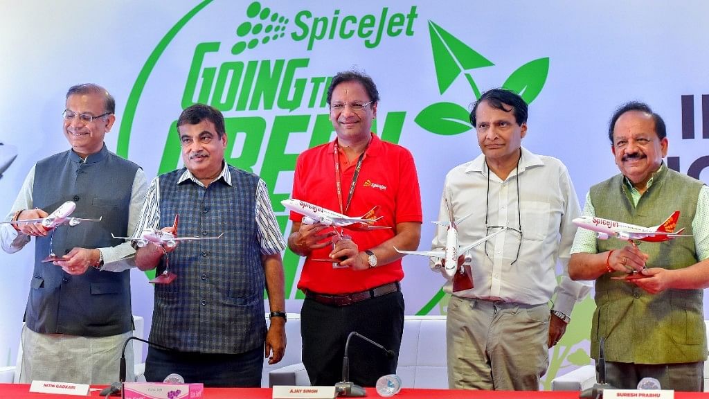 Union Ministers and SpiceJet CEO Ajay Singh (centre) pose for pictures with models of SpiceJet planes after the landing of the first flight, running on biofuel, at Delhi Airport terminal.