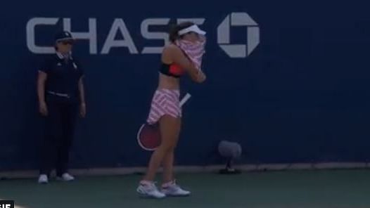 Alize Cornet changing on court during her US Open game.