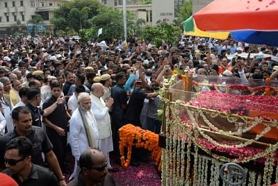 New Delhi: Prime Minister Narendra Modi and BJP chief Amit Shah walks along with the convoy carrying the mortal remains of former Prime Minister Atal Bihari Vajpayee; in New Delhi on Aug 17, 2018. (Photo: IANS)