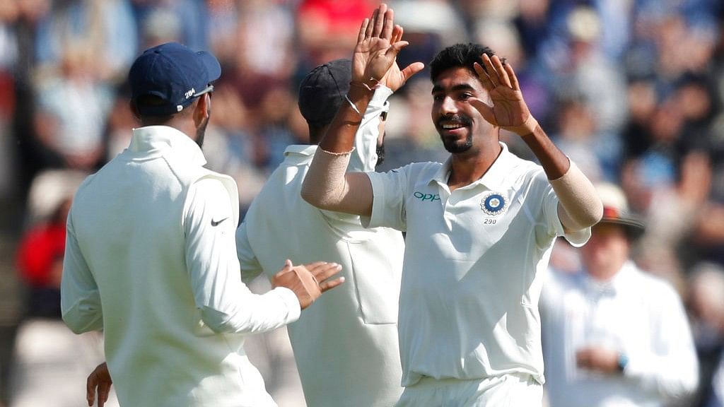 Jasprit Bumrah celebrates a wicket with his teammates.