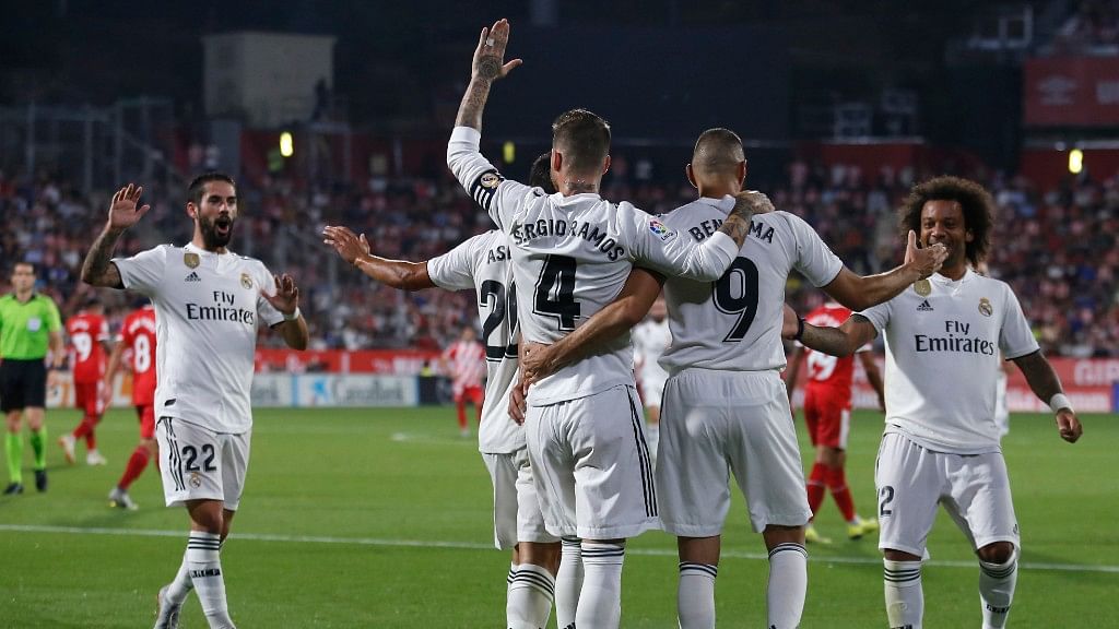 Real Madrid’s Karim Benzema, left, celebrates with team mates scoring his side’s 2nd goal during the Spanish La Liga soccer match between Girona and Real Madrid.