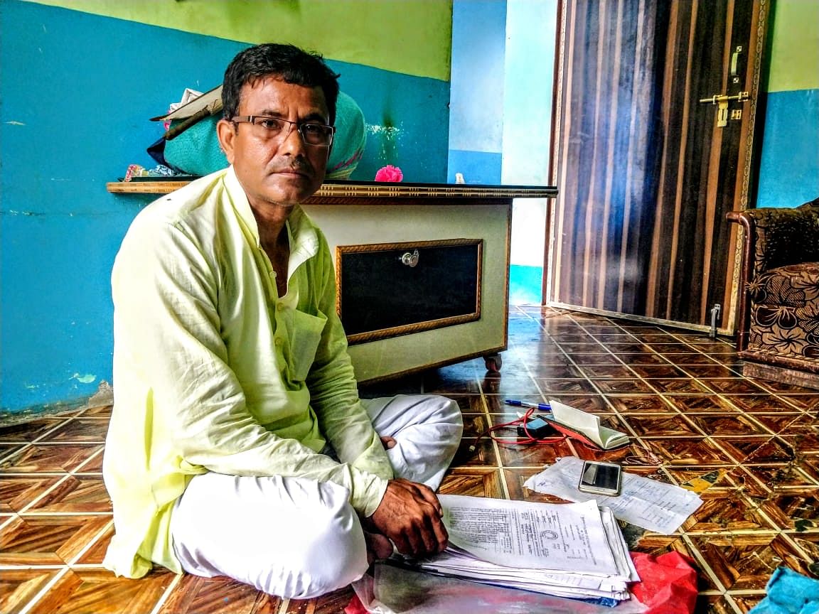 Naseem sitting in his home in Kairana. Here, he shows us the documents, including the FIRs for all the five cases.