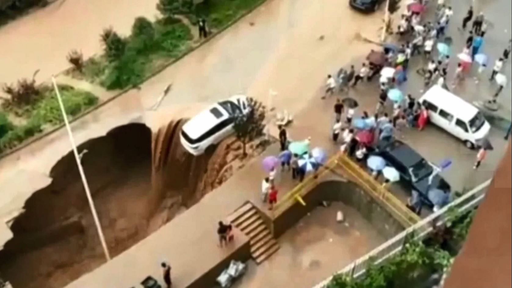 Flash floods had swept the car to the edge of the sinkhole.