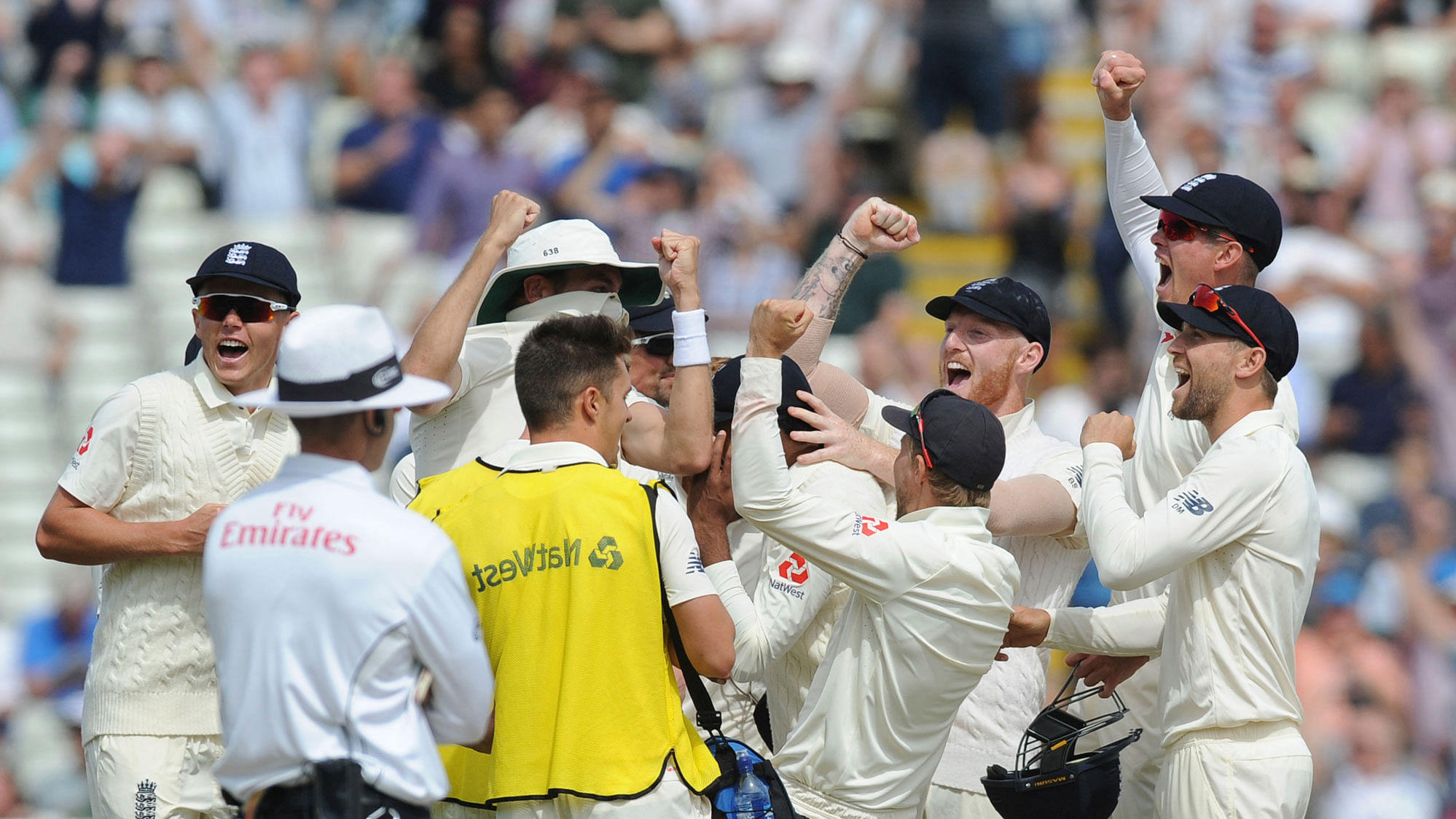 The England team celebrate after winning the first Test against India on Saturday.