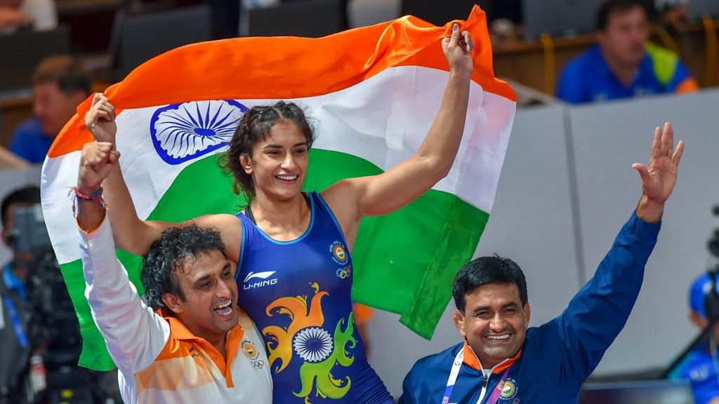 Vinesh Phogat celebrating with the Tricolour after winning the Gold medal at Asian Games