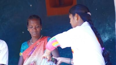 A midwife conducting basic tests on a pregnant woman.