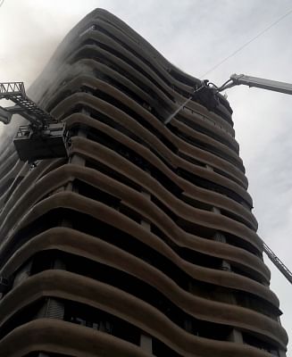 Mumbai: Fire fighters douse fire that broke out in the12th floor of 17-storeyed Crystal Tower building located in Parel, Mumbai, on  Aug 22, 2018. Four persons, including an elderly woman, were killed and 16 others injured, when a massive fire ripped through a highrise building. (Photo: IANS)