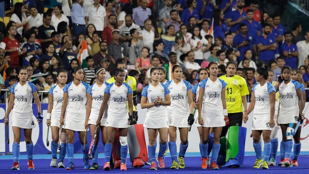 A dejected Indian women’s hockey team walks after losing to Japan.