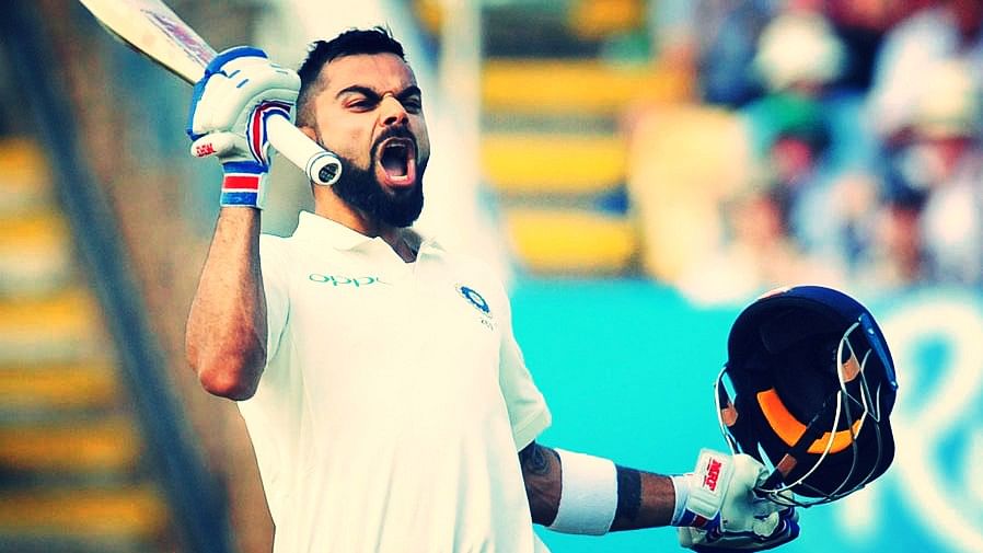 Virat Kohli celebrates after scoring a century on Day 2 of the first Test against England.