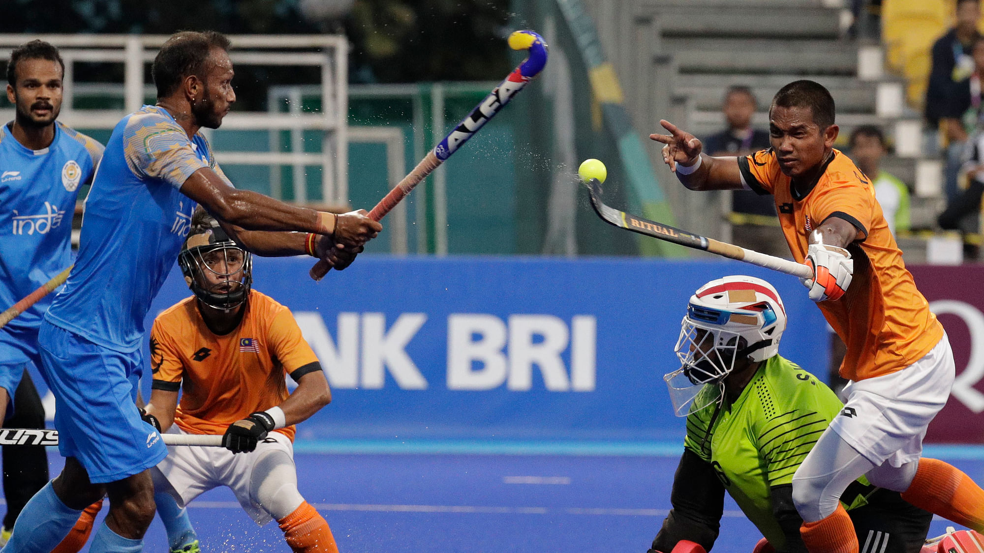 Malaysia’s Muhammad Abd Rahim, right, during their men’s hockey semi-final match against India at the 18th Asian Games in Jakarta, Indonesia.