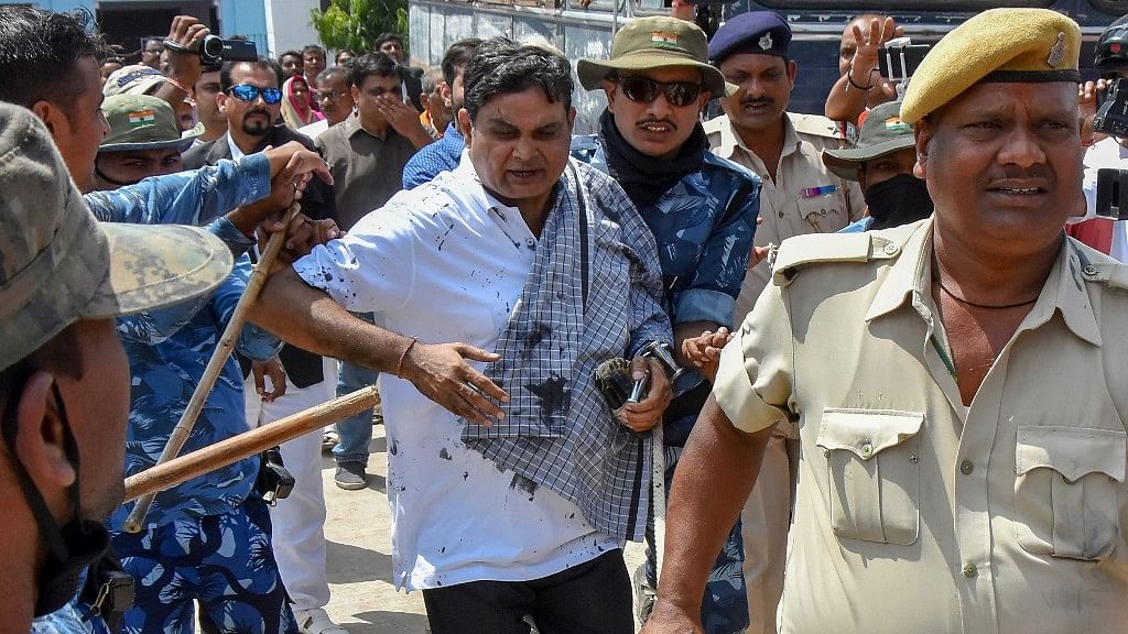 Main accused in the Muzaffarpur shelter home case Brajesh Thakur, after a woman allegedly threw ink on his face while he was being taken to a special POCSO court, in Muzaffarpur on Wednesday, Aug 8, 2018.