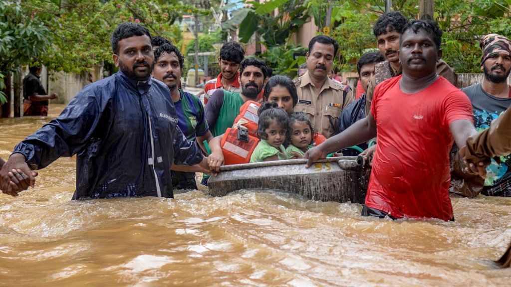Rescuers evacuate people from a locality in Thiruvananthapuram on Wednesday, 15 August.
