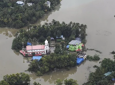 Kerala: An aerial view of the flood-hit areas of Kerala on Aug 18, 2018. Overflowing rivers and a series of landslides have caused the death of 180 people as of Saturday morning, with over three lakh people forced to move to some 2,000 relief camps. The disaster has triggered an unprecedented rescue and relief operation led by the Army, the Air Force and the Navy along with teams of National Disaster Response Force involving about 1,300 personnel and 435 boats. Prime Minister Narendra Modi on Sa