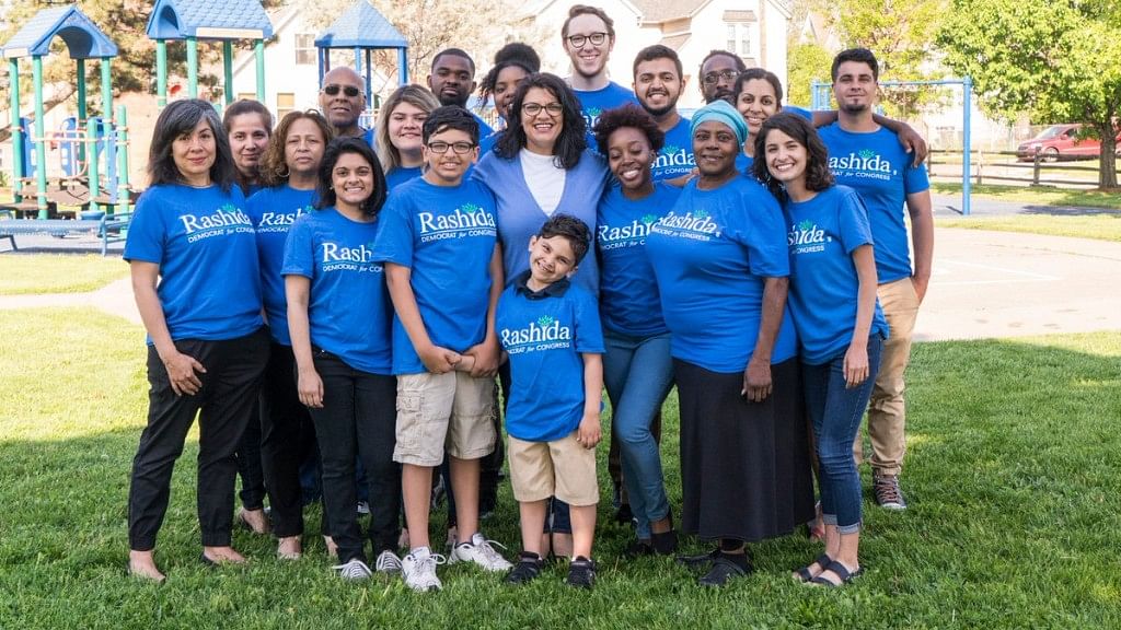 Rashida Tlaib (center), a mother of two and daughter of Palestinian immigrants once detained for disrupting a Donald Trump speech, made history on 8 August 2018, poised to become the first Muslim woman in US Congress.