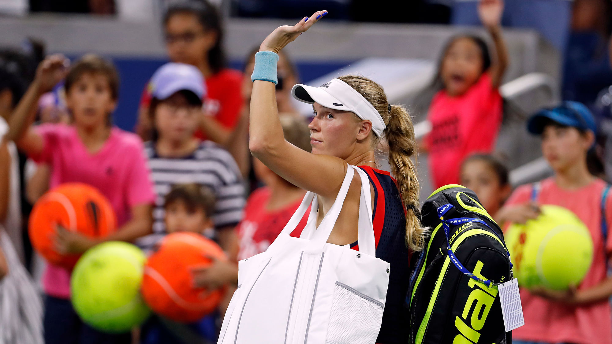 Caroline Wozniacki, of Denmark, waves as she leaves the court after losing to Lesla Tsurenko, of Ukraine, during the second round of the U.S. Open tennis tournament, Thursday