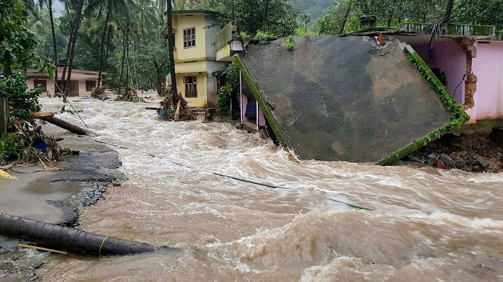 Roof of a house collapses following a flash flood, triggered by heavy rains, at Kodencheri in Kozhikode district of Kerala on 9 August.