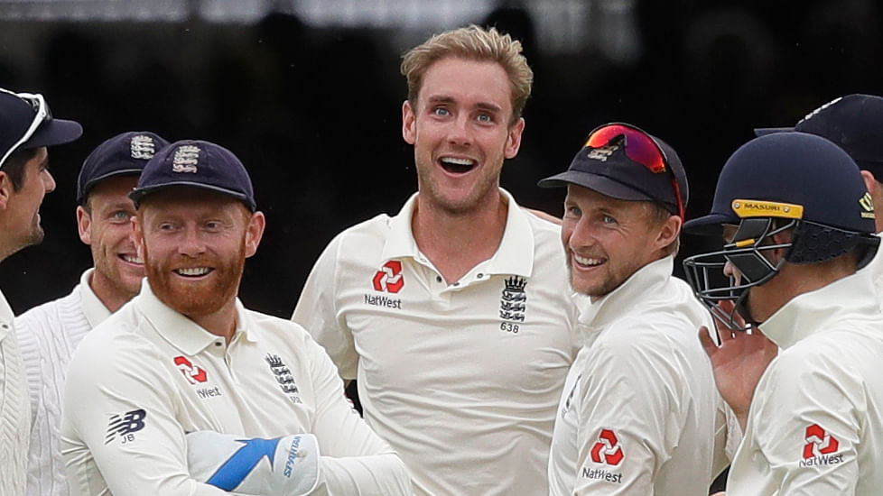 England’s Stuart Broad, centre, stands with his team as India’s Dinesh Karthik leaves the pitch during the fourth day of the second test match between England and India at Lord’s cricket ground in London, Sunday, Aug. 12, 2018.