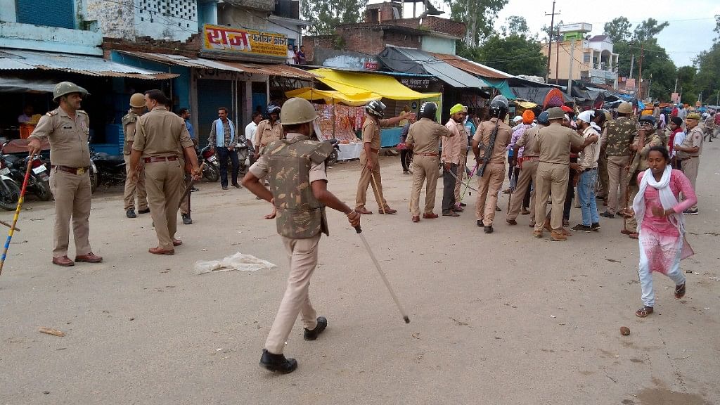 Policemen stand guard at a street in Banda town of Shahjahanpur after tension erupted on 25 August.&nbsp;