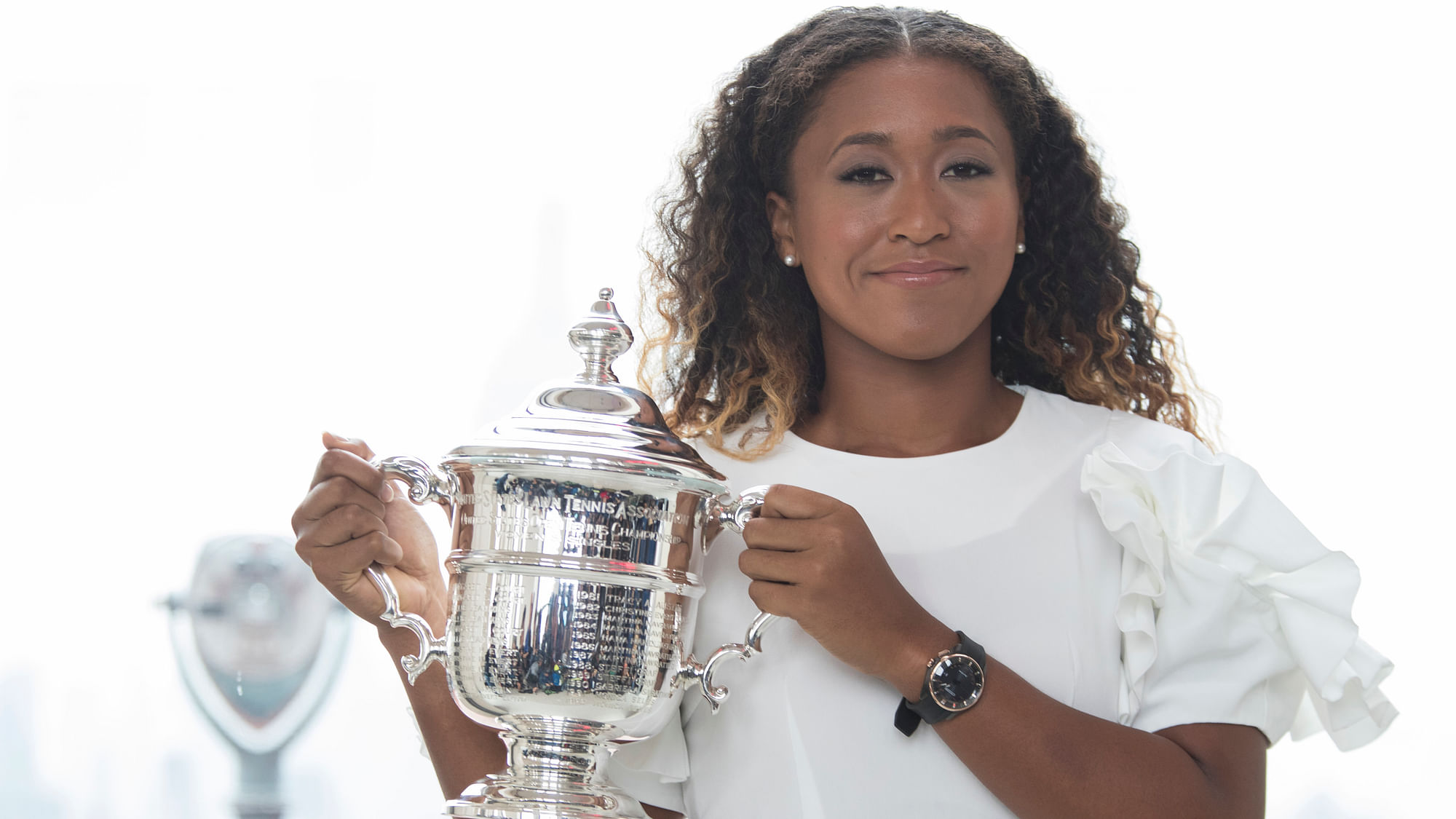 US Open women’s singles champion Naomi Osaka poses for photographers with her trophy at Top of the Rock Observation Deck at Rockefeller Center, Sunday, Sept. 9, 2018, in New York.&nbsp;