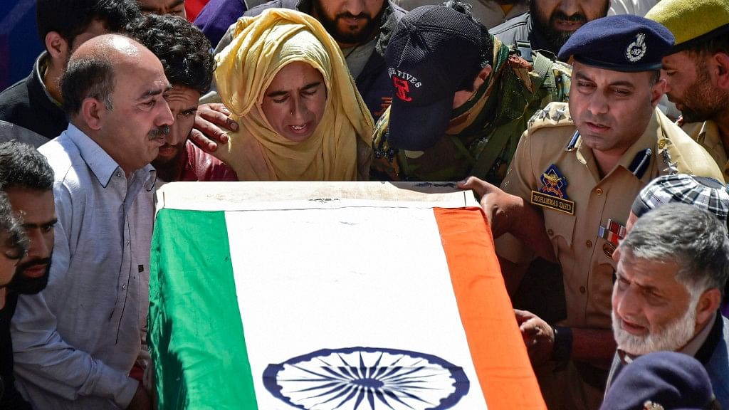 A woman relative and police officers shoulder  the coffin of slain police constable Nissar Ahmad Dhobi after a wreath-laying ceremony in Shopian on Friday, 21 September, 2018. The militants had abducted three SPOs and killed them.