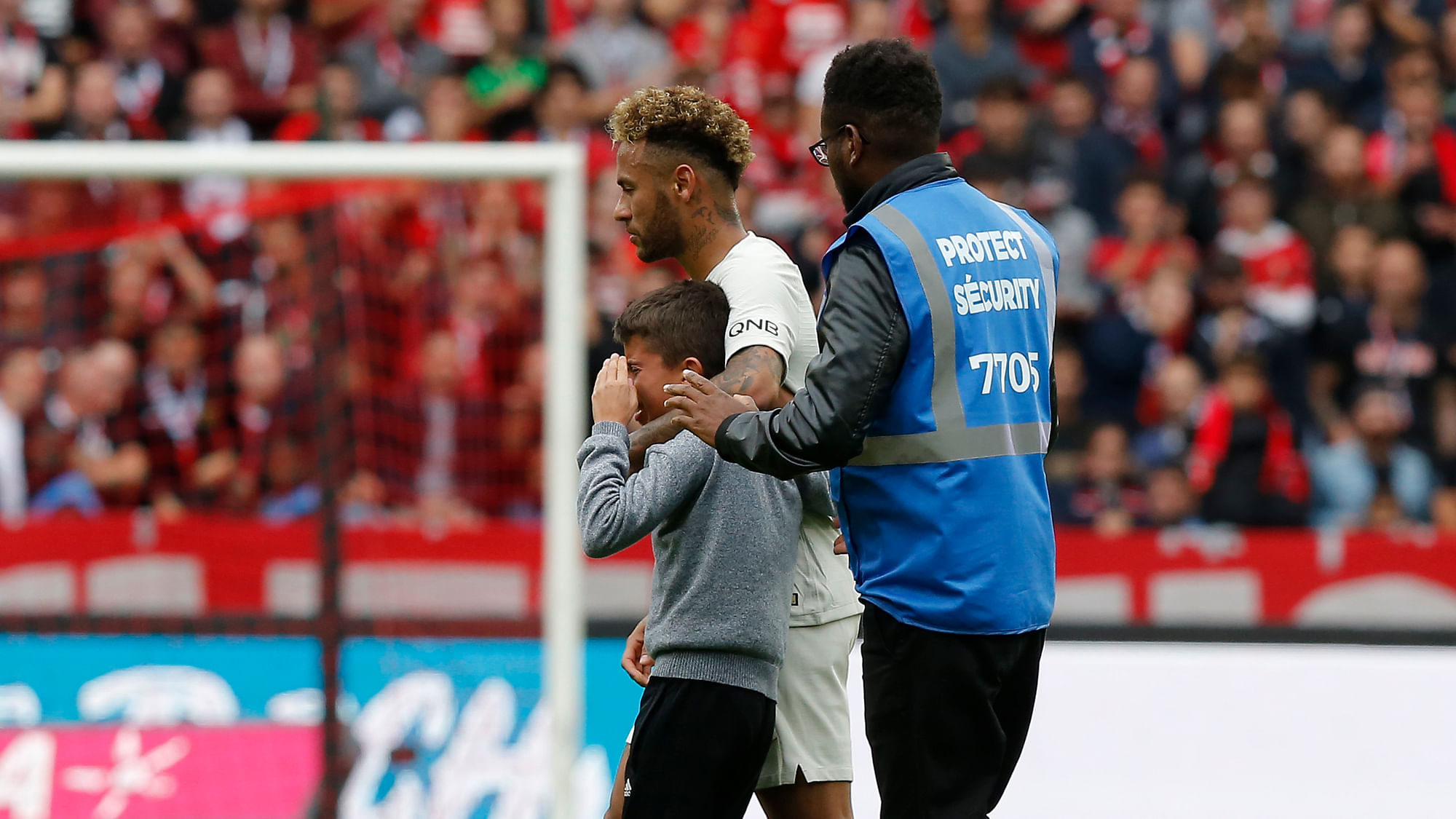 PSG’s Neymar shields a crying boy who ran onto the pitch from a security guard after their French League One soccer match between Rennes and Paris-Saint-Germain at Roazhon Park stadium in Rennes, western France, Sunday, Sept. 23, 2018.&nbsp;