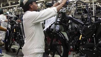 Employees work on the assembly line at the Honda Motorcycle &amp; Scooter India Pvt plant in Manesar.