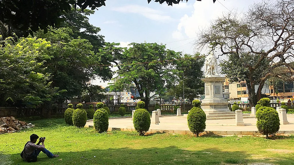 A youngster photographs the statue of King Edward VII, one of the eight statues located all around the park.
