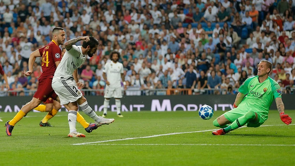 Roma goalkeeper Robin Olsen (right) defends a shot from Realmidfielder Isco during their Champions League match in Madrid on Wednesday. 