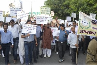 Agra: Workers, industrialists and social activists carrying placards and banners protest against the restrictions on industries in the eco-sensitive Taj Trapezium Zone spread over 10,400 sq.km.; in Agra on Sept 19, 2018. (Photo: IANS)