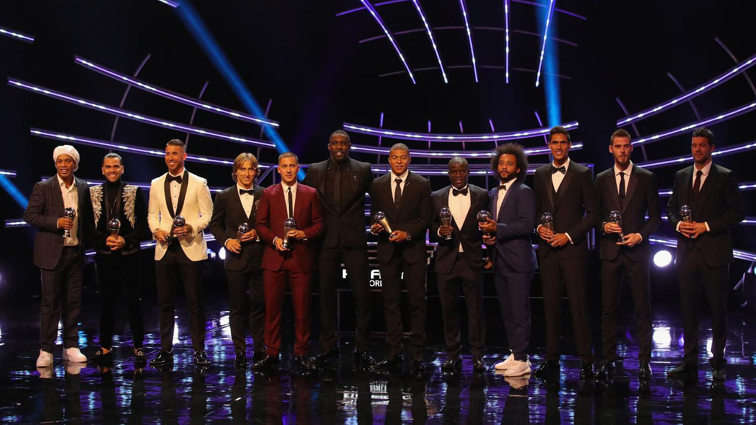 Host Idris Elba, center, poses with the 11 players of the top team with players David De Gea, Dani Alves, Marcelo, Sergio Ramos, Raphael Varane, Eden Hazard, N’Golo Kante, Luka Modric, Cristiano Ronaldo, Kylian Mbappe and Lionel Messi during the ceremony of the Best FIFA Football Awards.
