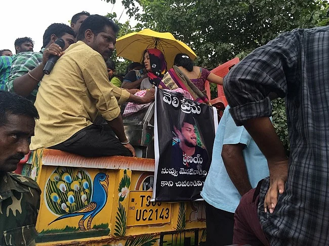 Posters of Pranay Permulla being carried by sympathizers across the town.