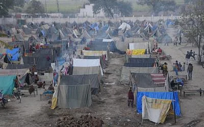 They survived the bloody riots in September, but the winter chill seems determined to do some real harm to over 50,000 people displaced during the Muzaffarnagar riots and now living in dozen-odd relief camps. One of these - Malakpur relief camp in Shamli district -- in pictures offers no respite to riot-affected people - women, aged and children alike. The December chill has reportedly claimed lives of 34 children so far. More are likely to lose the battle against damp and dew in the coming mont