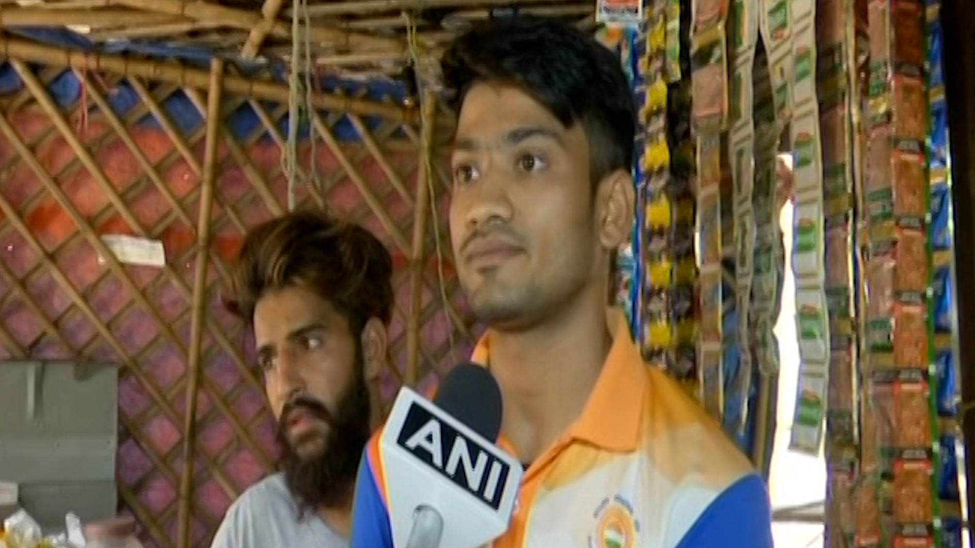 Harish Kumar speaks to the media after winning a bronze medal in the team Sepaktakraw event at the Asian Games.