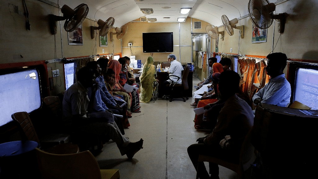 Patients wait for their dental checkup on the Lifeline Express, a hospital built inside a seven-coach train, at a railway station in Jalore, Rajasthan.&nbsp;
