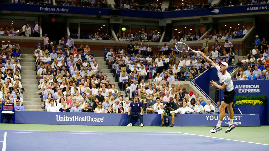 John Millman, of Australia, serves to Novak Djokovic, of Serbia, during the quarter-finals of the US Open on Wednesday.