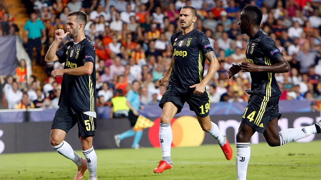 Juventus midfielder Miralem Pjanic (left) celebrates with teammates Leonardo Bonucci and Blaise Matuidi (right) after scoring a penalty during the Champions League match against Valencia on Wednesday.