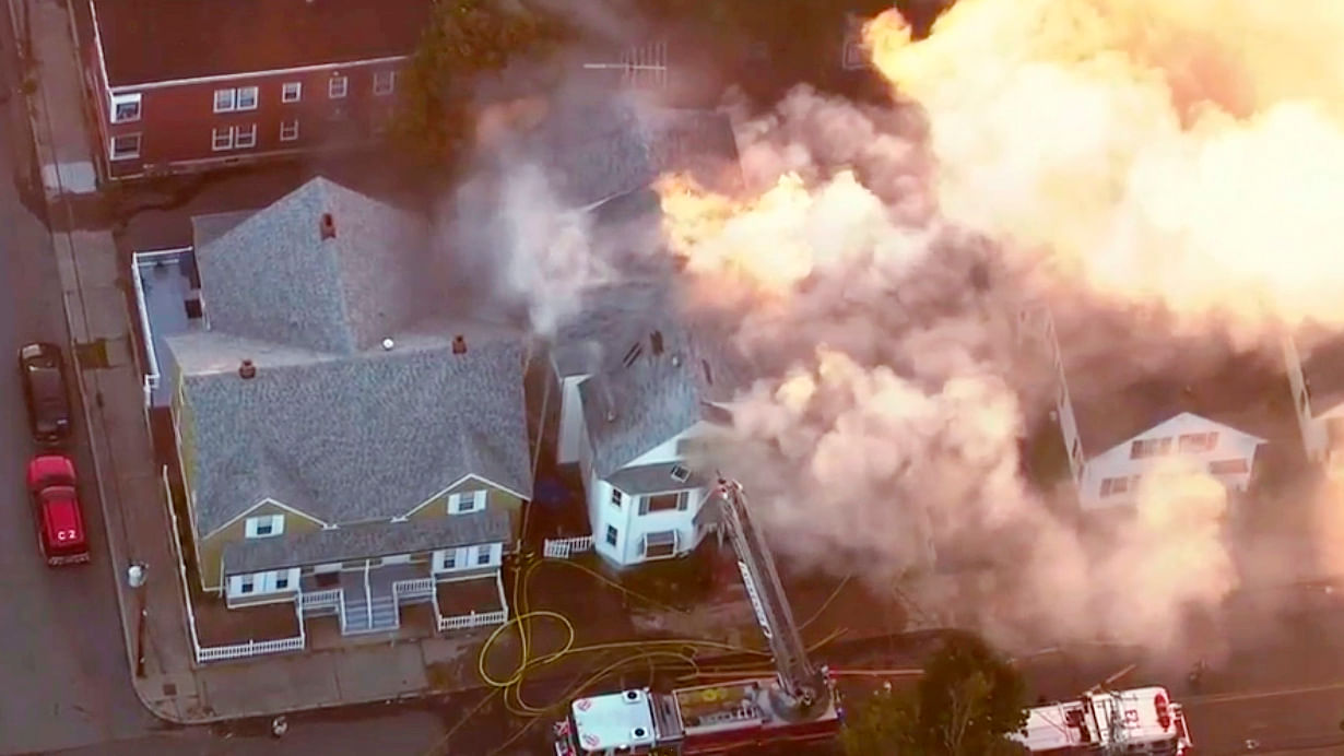 In this image take from video provided by WCVB in Boston, firefighters battle a raging house fire in Lawrence, Mass, a suburb of Boston.
