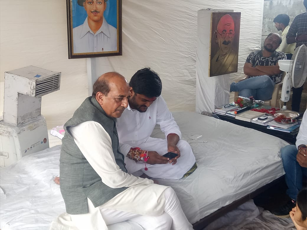 Dinesh Trivedi of the Trinamool Congress meets Hardik Patel.