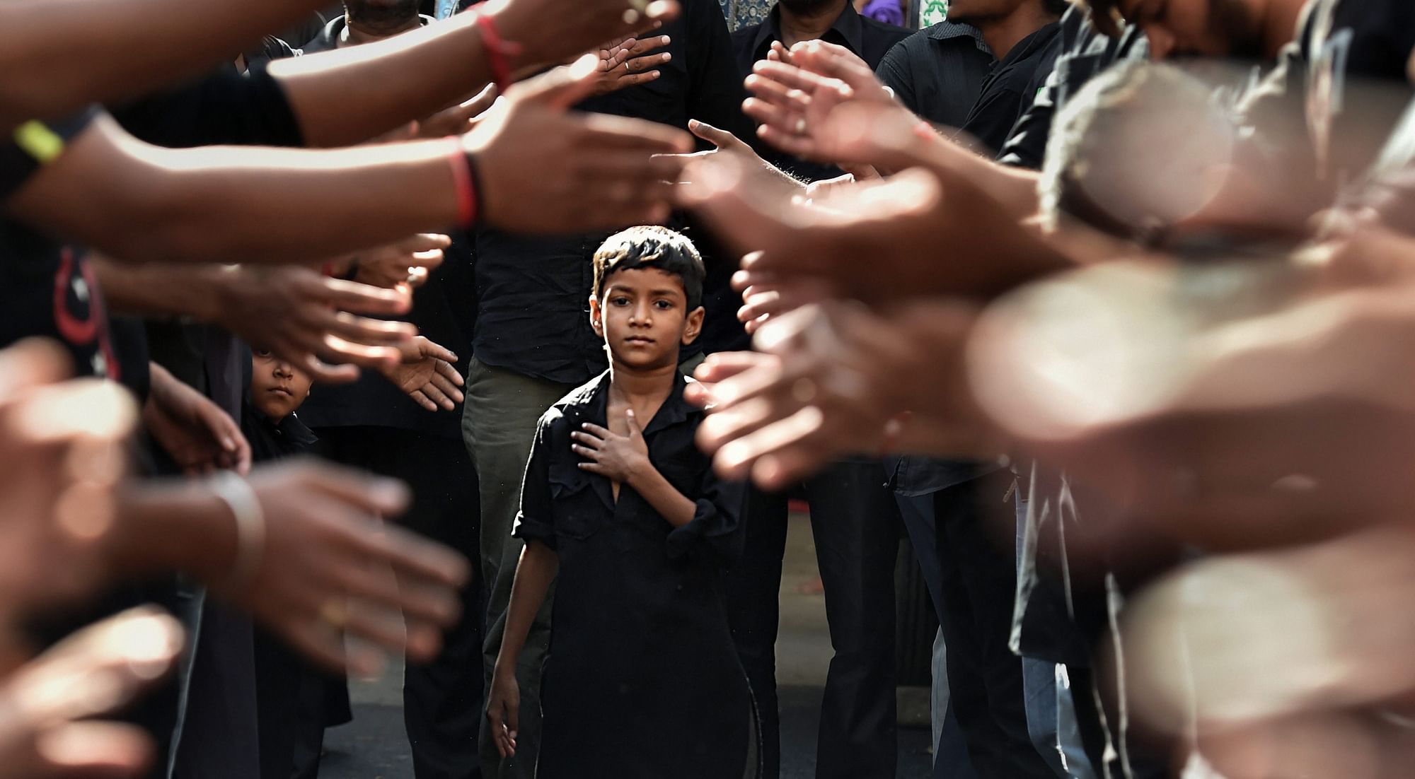 A boy participates in mourning during a Muharram procession, in Ahmedabad, Gujarat.