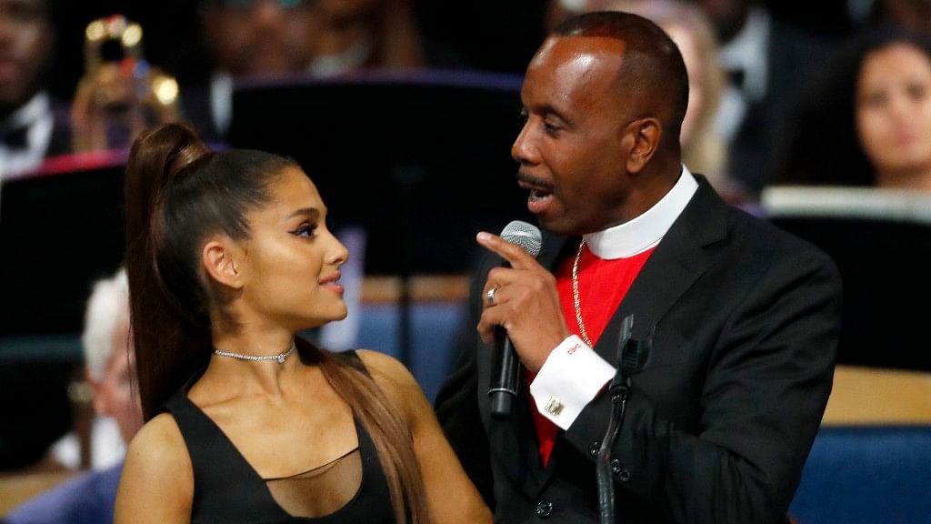 Bishop Charles H. Ellis, III, right, speaks with Ariana Grande after she performed during the funeral service for Aretha Franklin in Detroit on Aug 31. (AP Photo/Paul Sancya)