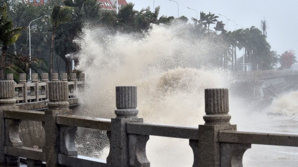 In this photo released by Xinhua News Agency, waves crash onto the coastline in Zhuhai in southern China’s Guangdong Province.