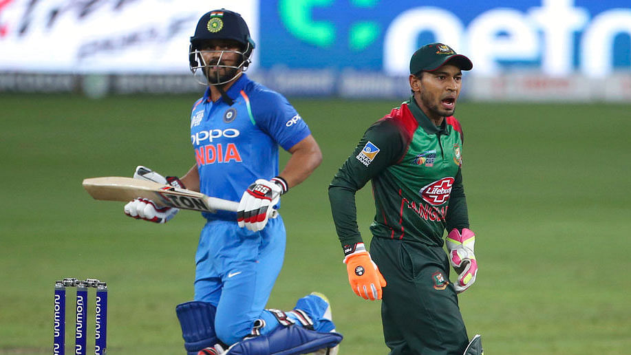 Bangladesh’s Mushfiqur Rahim, right, gestures to his teammate as India’s Kedar Jadhav, left, completes a run during the Asia Cup final.