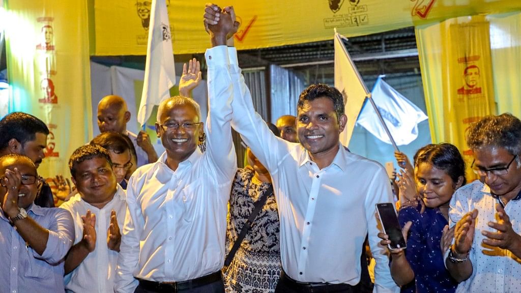 Maldives’ opposition presidential candidate Ibrahim Mohamed Solih, third left, celebrates his victory.