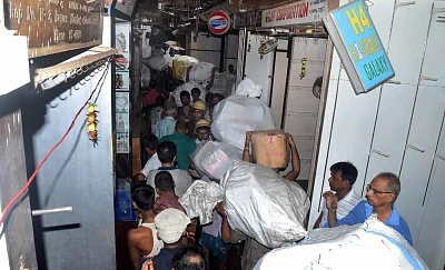 Kolkata: Labourers carry goods to safe place from Bagri Market where a massive fire broke out yesterday; in Kolkata on Sept 16, 2018. (Photo: Kuntal Chakrabarty/IANS)