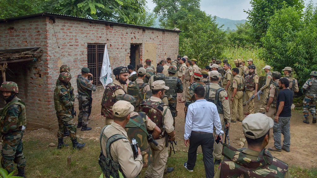 Security forces personnel near the house where terrorists were holed up during an encounter in the Kakriyal area of Reasi district. 