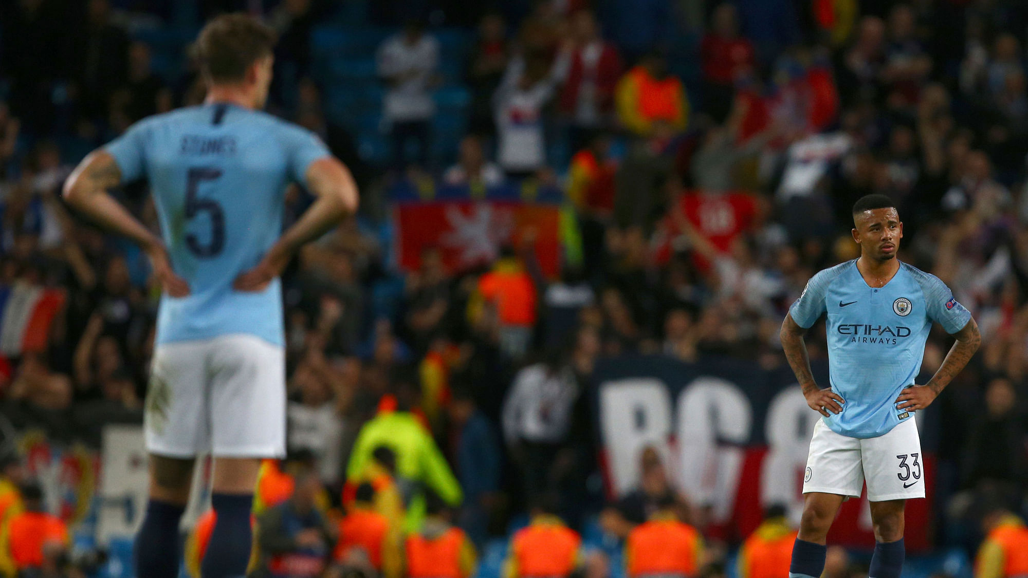 Manchester City’s Gabriel Jesus, right, and Manchester City’s John Stones, left, stand with their hands on their hips after Lyon score their second goal during the Champions League Group F soccer match.